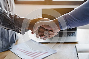 Two businessmen handshaking in meeting after final project agreement deal done