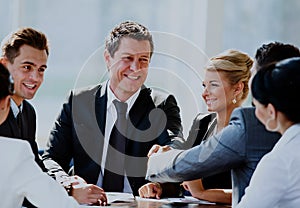 Two businessmen handshaking after striking grand deal.