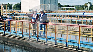 Two businessmen having a discussion about a biological wastewater treatment plant