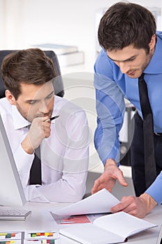 Two businessmen having discussion in office.