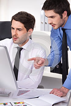 Two businessmen having discussion in office.