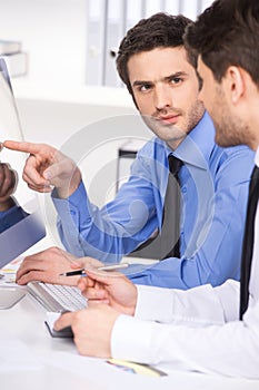 Two businessmen having discussion in office.