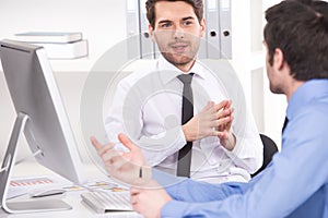 Two businessmen having discussion in office