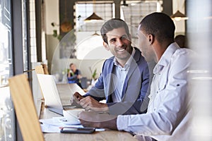 Two Businessmen Having Informal Meeting In Coffee Shop