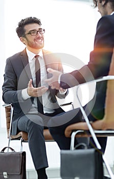 Two businessmen holding briefcases near themselves