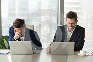 Two businessmen laughing out loud, good positive emotions at wor