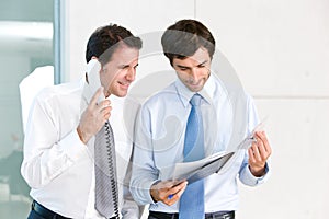 Two businessmen looking at documents