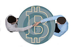 Two businessmen making a peer to peer bitcoin deal shake hands