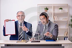 Two businessmen and meditation balls on the table