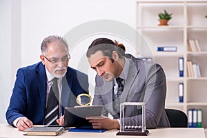 Two businessmen and meditation balls on the table