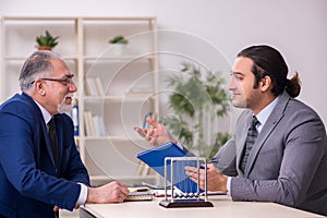 Two businessmen and meditation balls on the table