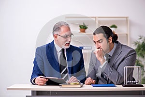 Two businessmen and meditation balls on the table