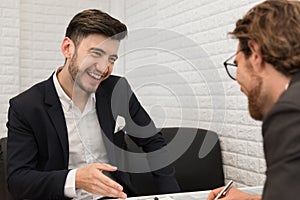 Two businessmen are negotiating a trade agreement together. Business and meeting concept. Job and occupation interview theme.