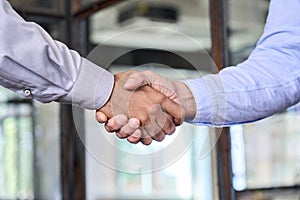 Two businessmen shake hands with business handshake concept.