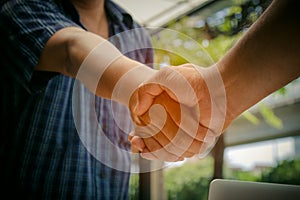 Two businessmen shaking hand after contract meeting