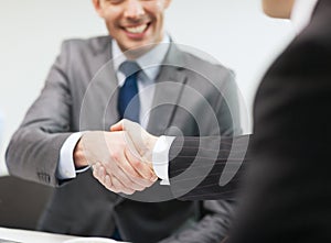 Two businessmen shaking hands in office