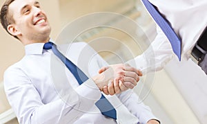 Two businessmen shaking hands in office