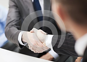 Two businessmen shaking hands in office