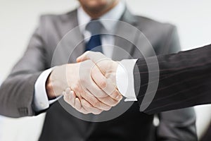 Two businessmen shaking hands in office