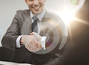 Two businessmen shaking hands in office