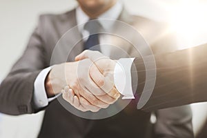 Two businessmen shaking hands in office