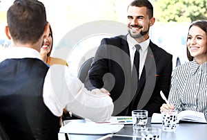 Two businessmen shaking hands in office