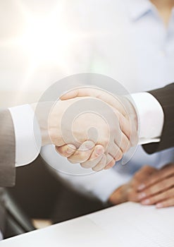 Two businessmen shaking hands in office