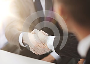 Two businessmen shaking hands in office