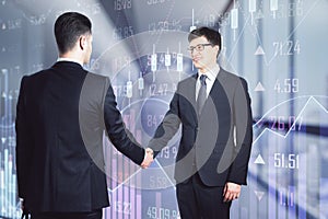 Two businessmen shaking hands in an office corridor, reaching an agreement. Communication and cooperation concept