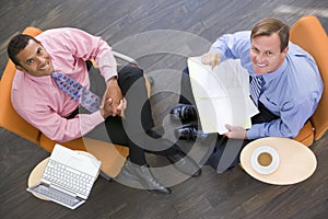 Two businessmen sitting indoors having a meeting