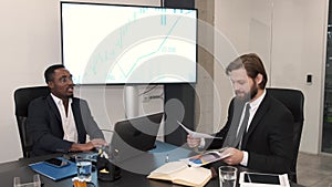 Two businessmen in suits having a discussion at office