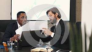 Two businessmen in suits having a discussion at office