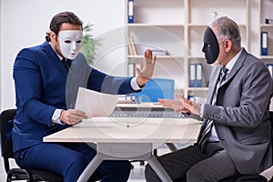 Two businessmen wearing masks during negotiations