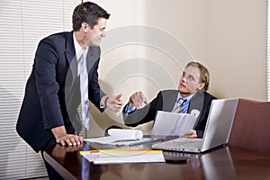 Two businessmen working in boardroom