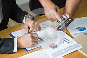 Two businessmen working on graphs in office, Business accounting