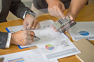 Two businessmen working on graphs in office, Business accounting