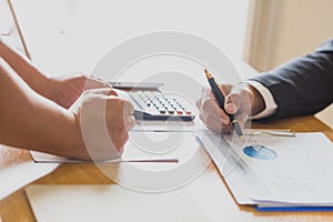 Two businessmen working on graphs in office, Business accounting