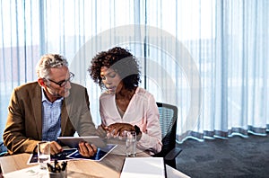 Two businessmen working on a tablet computer