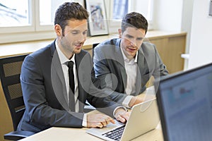 Two businessmen working together on a project in the office