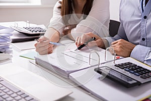 Two Businesspeople Checking Invoice