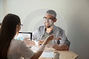 Two businesspeople discussing details of a contract.