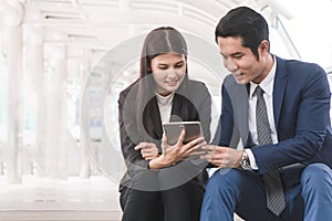 Two businesspeople discussing project data in  tablet computer in meeting.  Have copy space for text