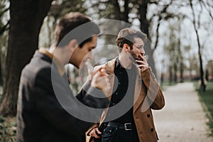 Two businesspeople in discussion while walking in the park.