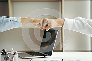 Two businesspeople fist bump dealing mission business with smile