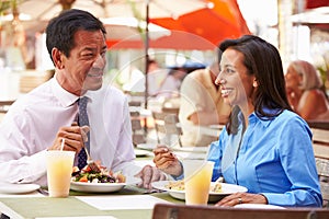 Two Businesspeople Having Meeting In Outdoor Restaurant