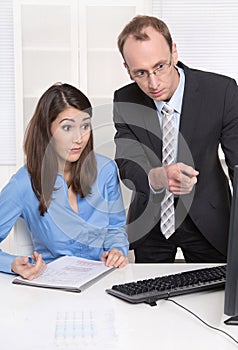 Two businesspeople in the office - discussion or bullying at work