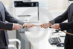 Two Businesspeople Playing Tug Of War