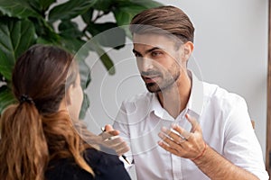 Two businesspeople talking focus on excited brainstorming caucasian employee