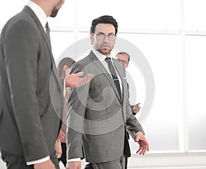 Two businesspeople walking in corridor talking