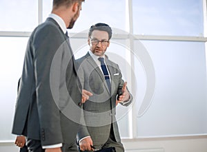 Two businesspeople walking in corridor talking